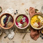 Colorful smoothie bowls topped with fresh fruit, granola, and seeds