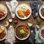 Six healthy dinner plates with chicken meatballs, pan-seared chicken, chimichurri steak, garlic butter salmon, a ground beef sweet potato bowl and steak and eggs