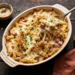 Golden creamy chicken cordon bleu pasta bake with melted Swiss cheese and crispy panko topping