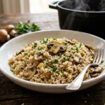 Bowl of fluffy mushroom rice with golden sliced mushrooms and parsley for an easy dinner
