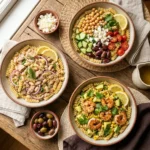 Tuna and white bean pasta salad with rotini, cherry tomatoes, red onion and parsley in a rustic ceramic bowl